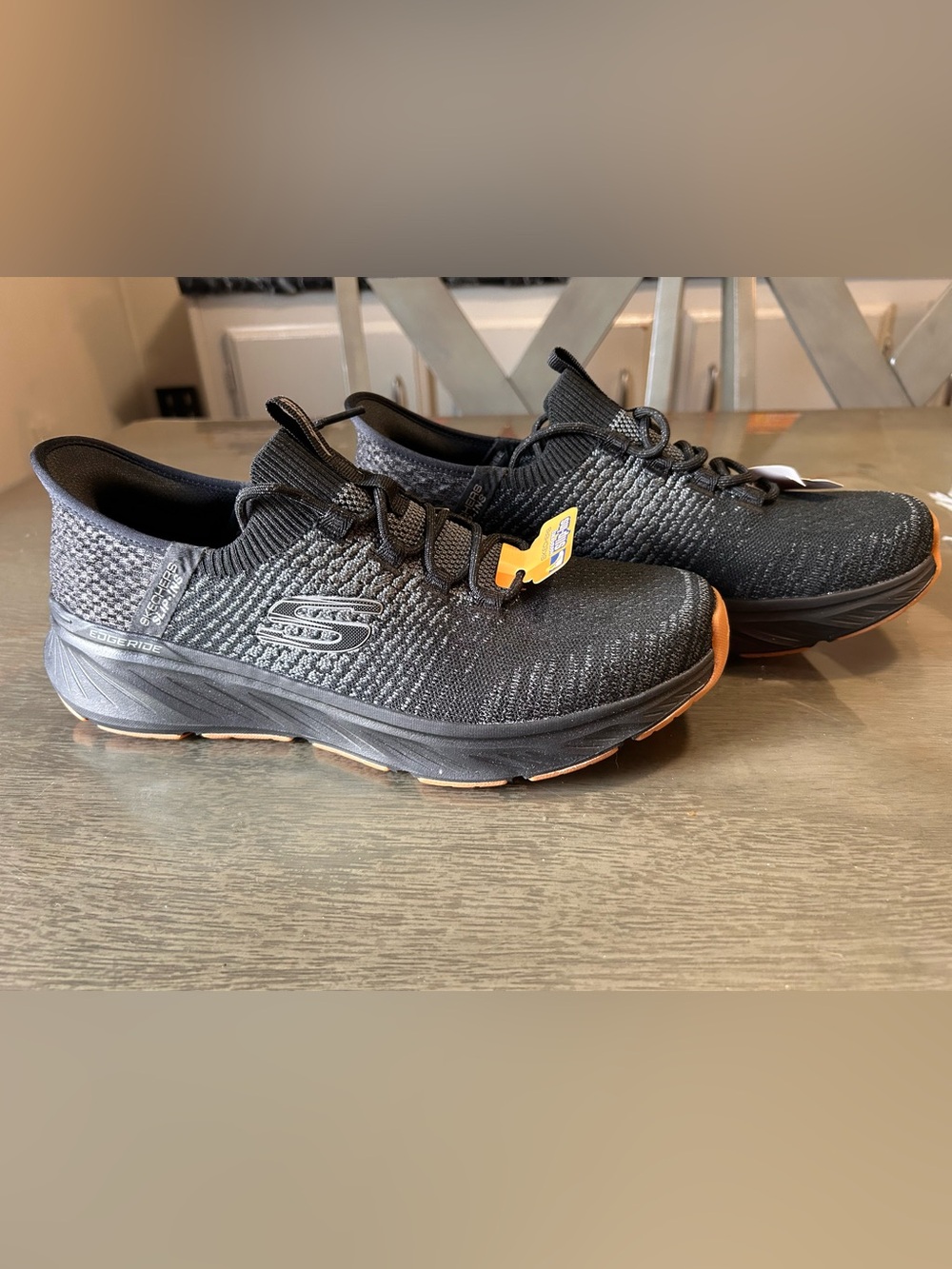 Skechers Men's Black Knit Athletic Slip-On Sneakers with Orange Sole Accents